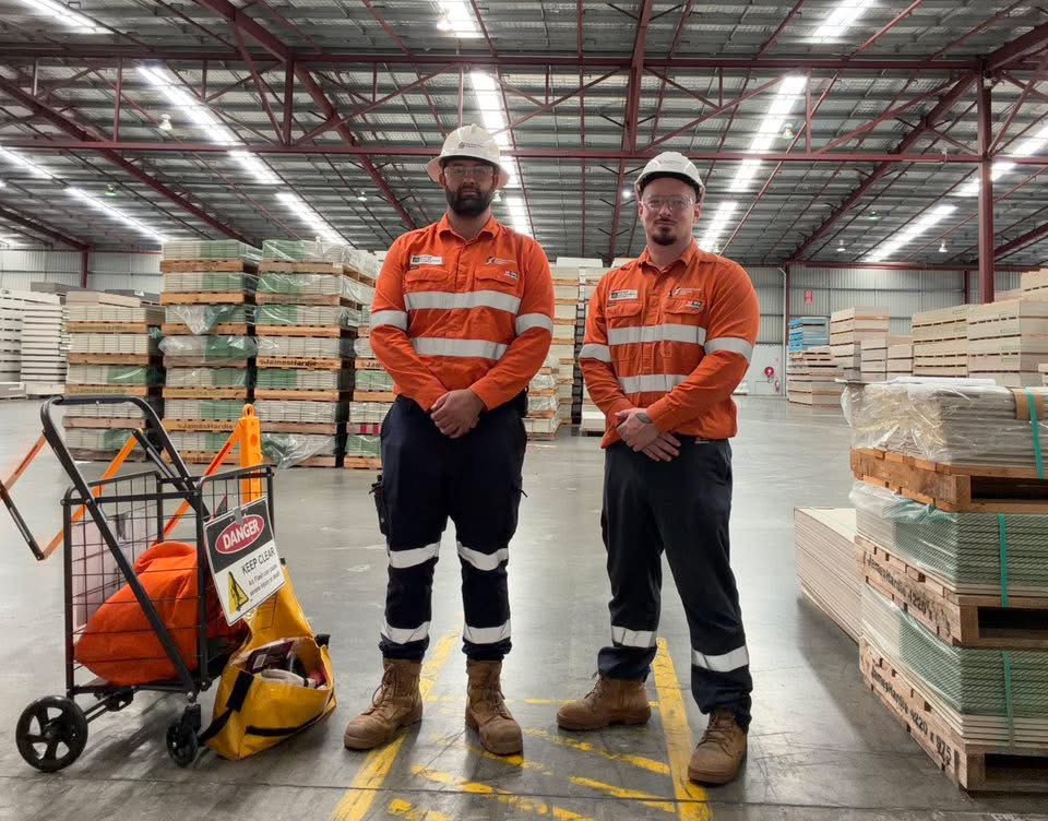 Two electricians on site in a warehouse